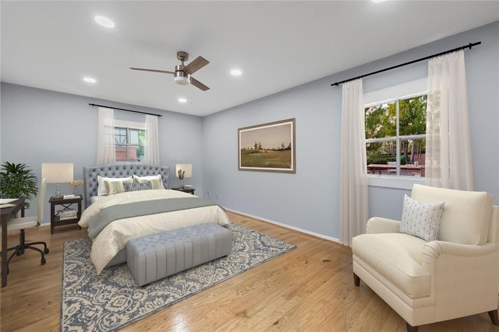 6851 Roswell Road, Unit E4 Atlanta, GA 30328 - Photo 16 of 26 a bedroom with a large bed couch and windows