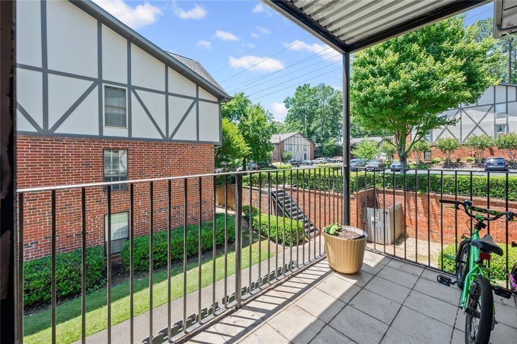 6851 Roswell Road, Unit E4 Atlanta, GA 30328 - Photo 17 of 26 a view of a balcony with a floor to ceiling window and wooden fence