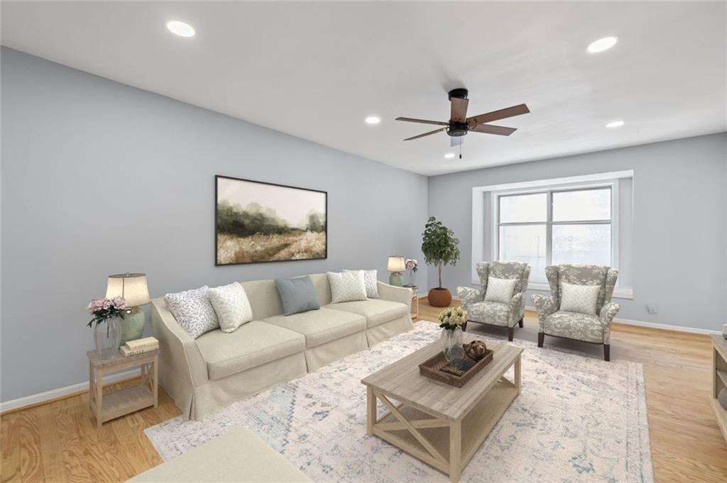 6851 Roswell Road, Unit E4 Atlanta, GA 30328 - Photo 2 of 26 a living room with furniture and a large window