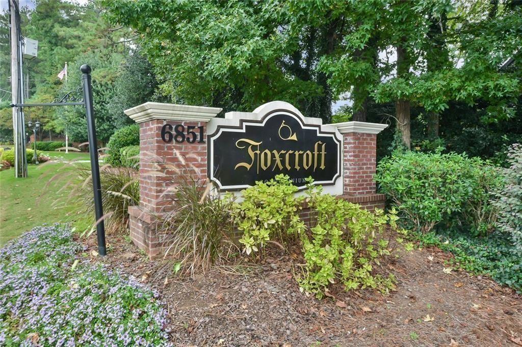 6851 Roswell Road, Unit E4 Atlanta, GA 30328 - Photo 26 of 26 a view of a park that has a sign board large trees and plants