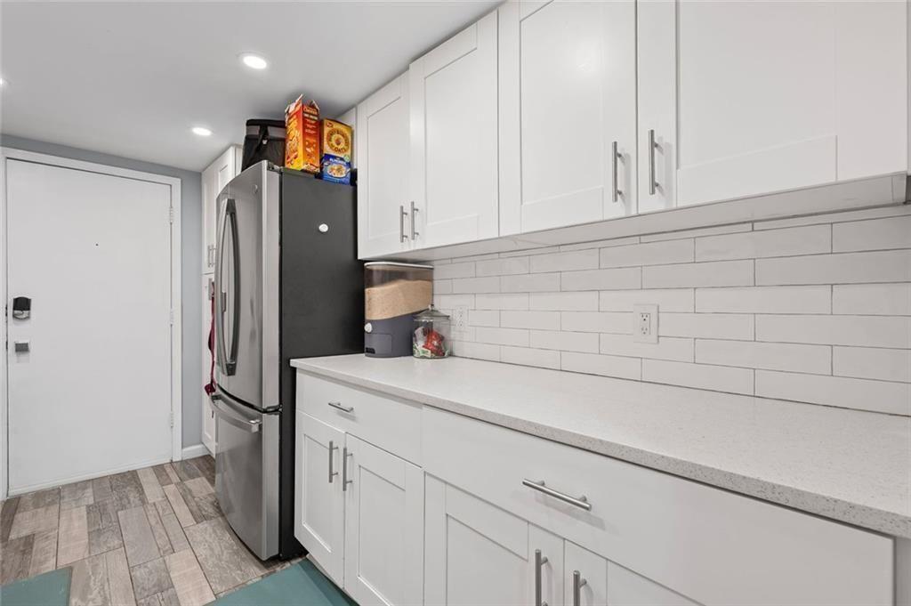 6851 Roswell Road, Unit E4 Atlanta, GA 30328 - Photo 4 of 26 a kitchen with stainless steel appliances a refrigerator and cabinets