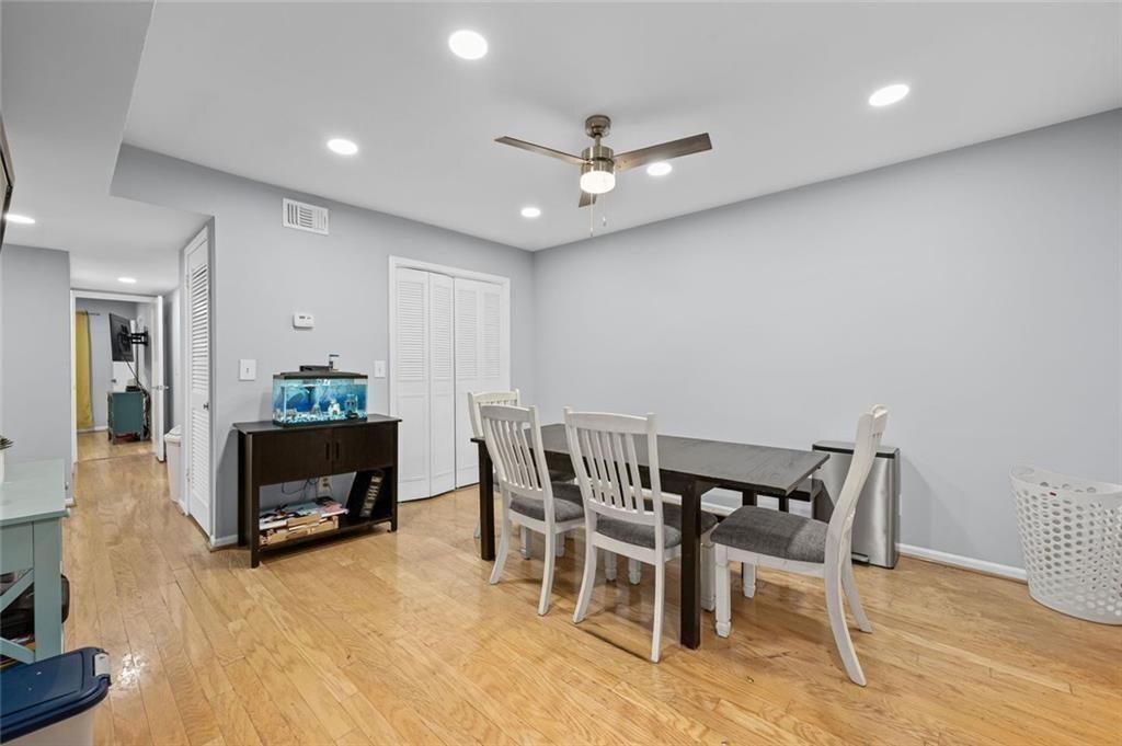 6851 Roswell Road, Unit E4 Atlanta, GA 30328 - Photo 8 of 26 a view of a dining room with furniture and wooden floor