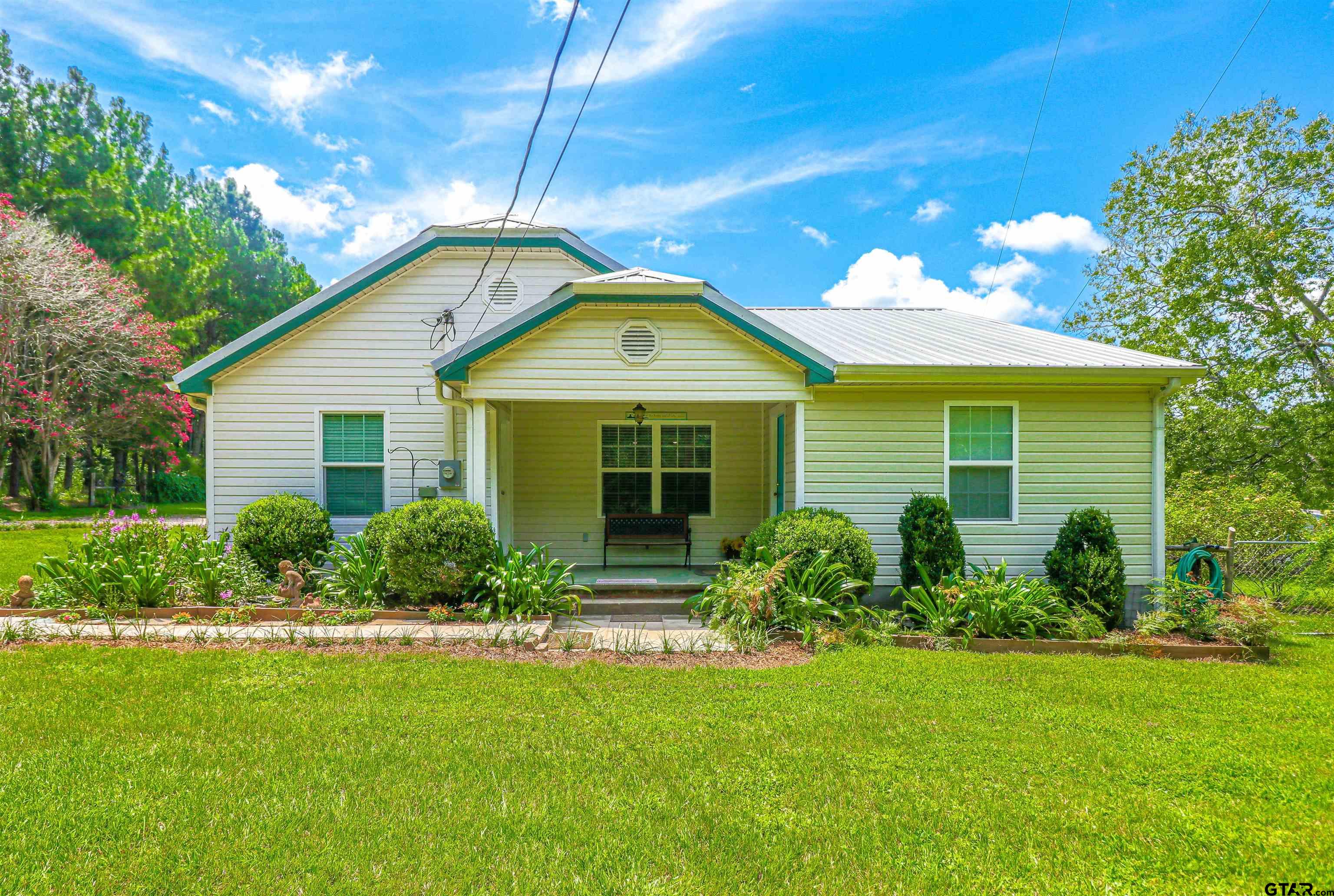 a front view of house with yard and green space