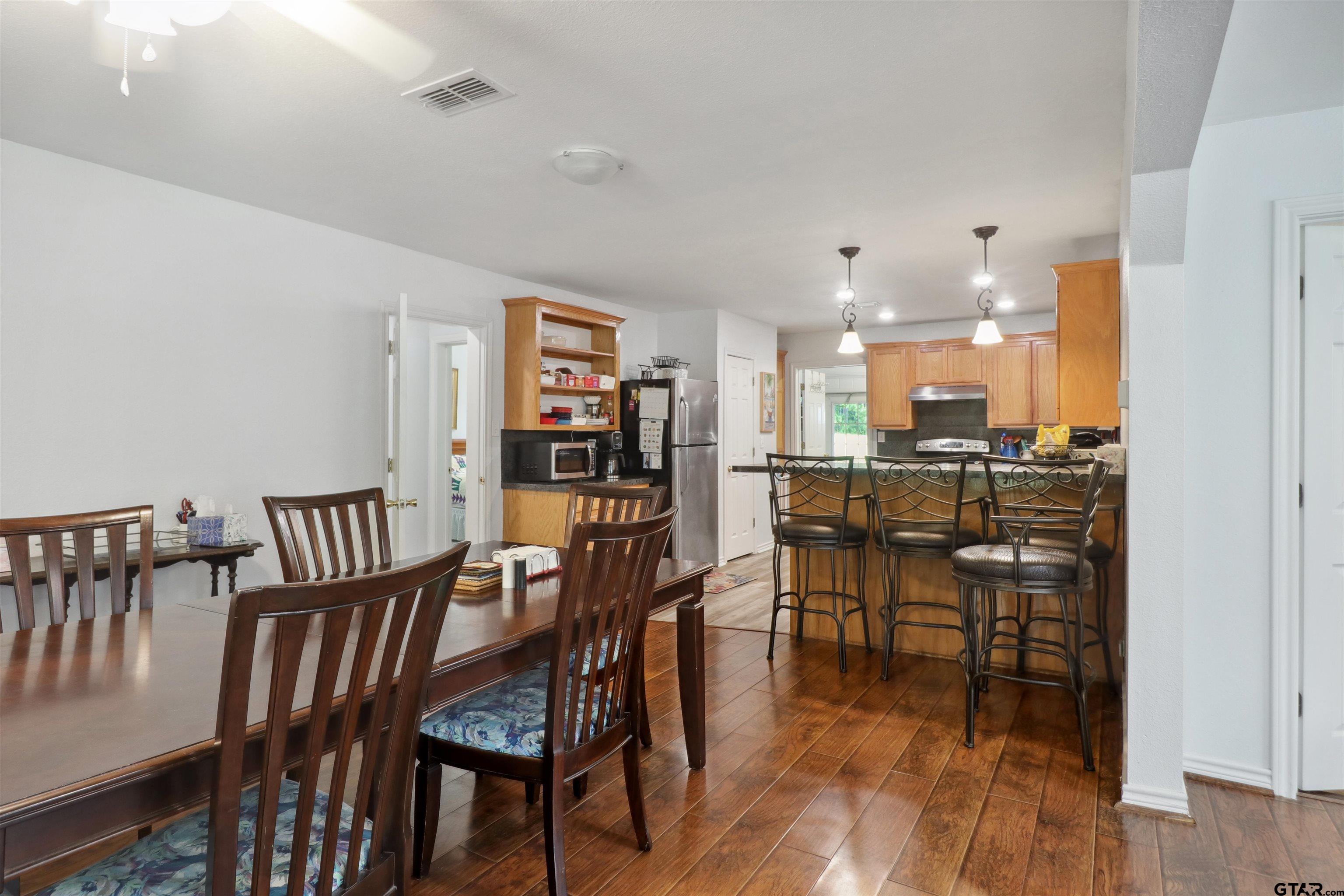 830 County Road 2201 Rusk, TX 75785 - Photo 15 of 40 a view of a dining room with furniture and wooden floor