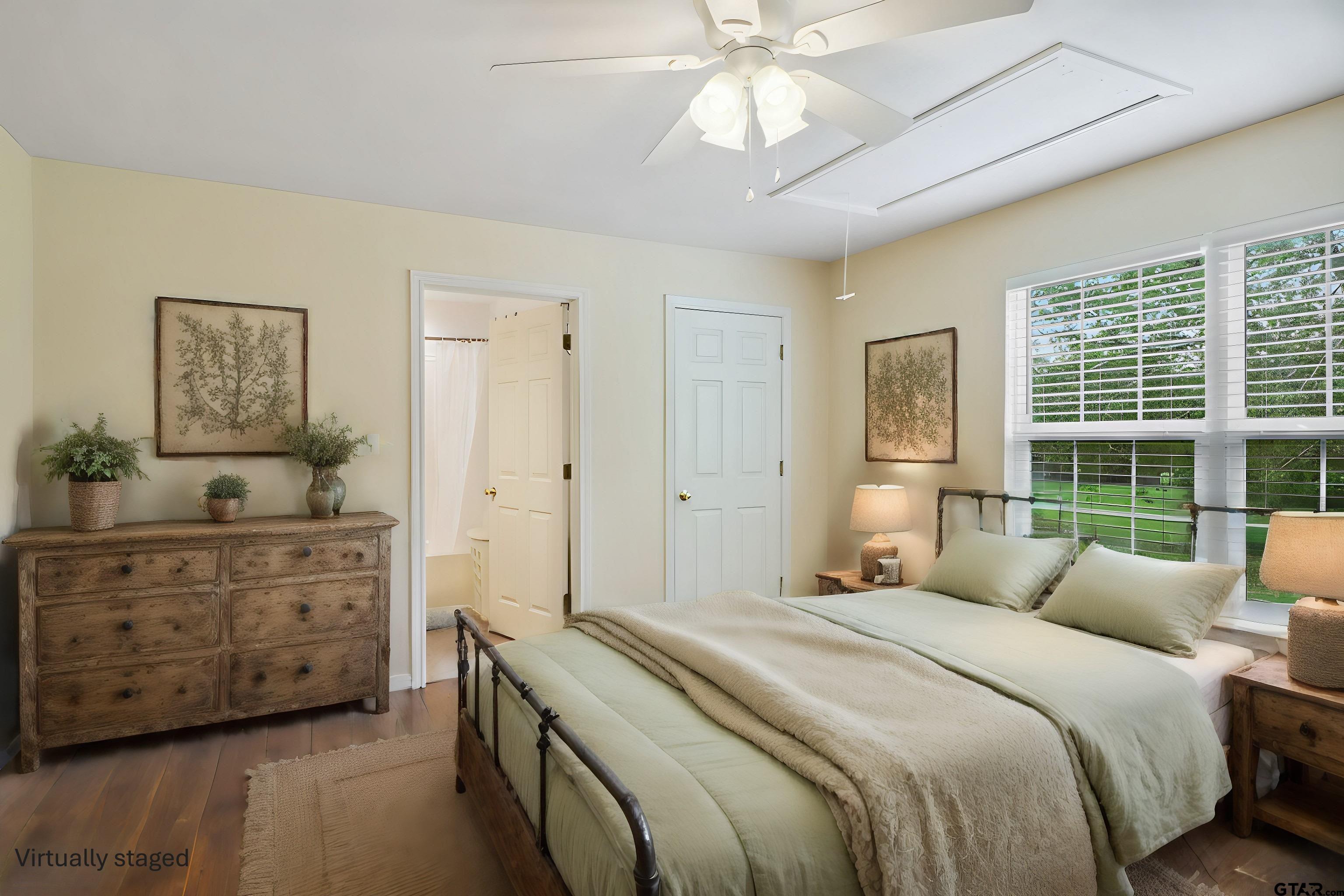 830 County Road 2201 Rusk, TX 75785 - Photo 22 of 40 a bedroom with a bed and a chandelier