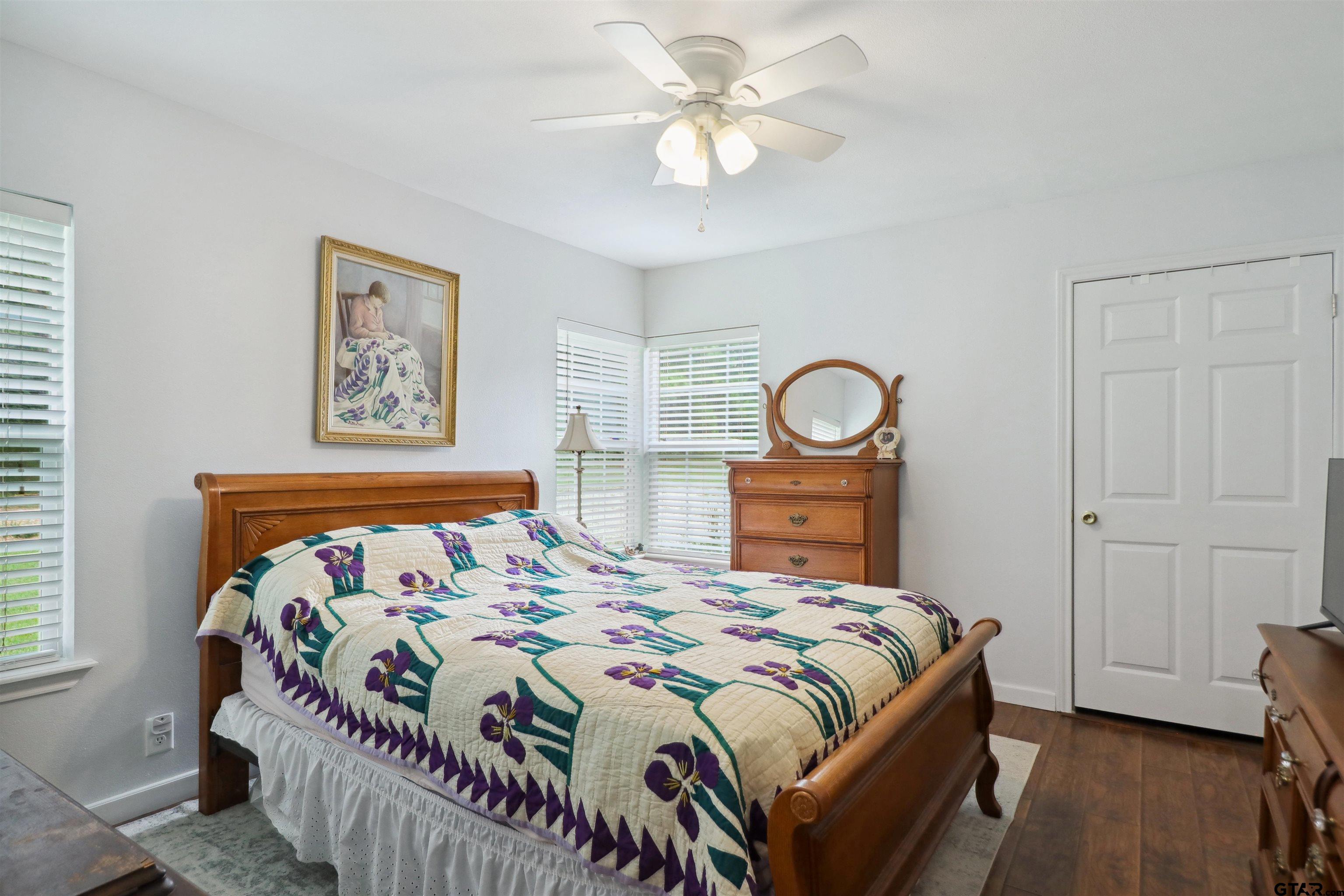830 County Road 2201 Rusk, TX 75785 - Photo 26 of 40 a bedroom with a bed and a chandelier