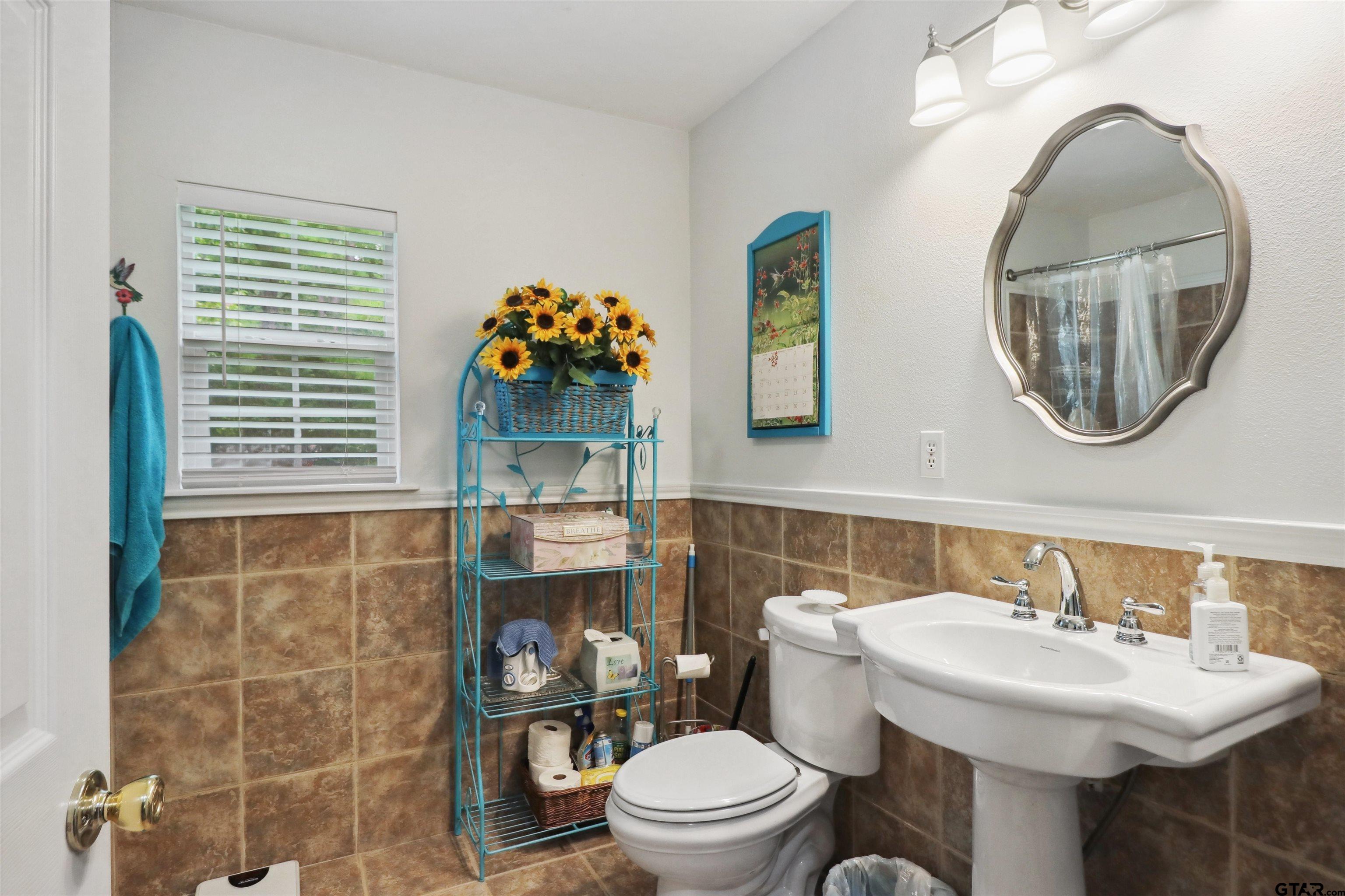 830 County Road 2201 Rusk, TX 75785 - Photo 28 of 40 a bathroom with a sink a toilet and a mirror