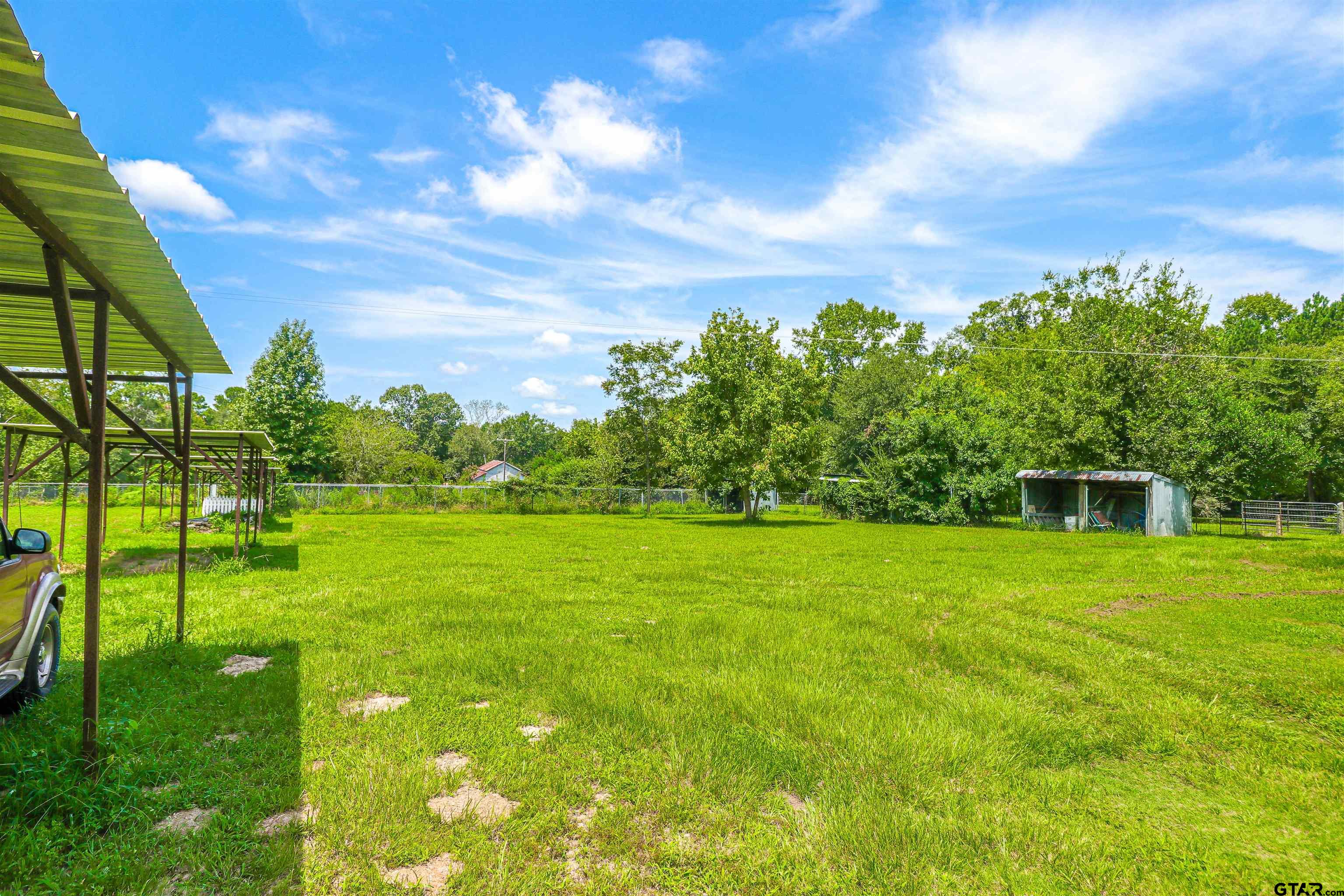 830 County Road 2201 Rusk, TX 75785 - Photo 35 of 40 a backyard of a house with table and chairs
