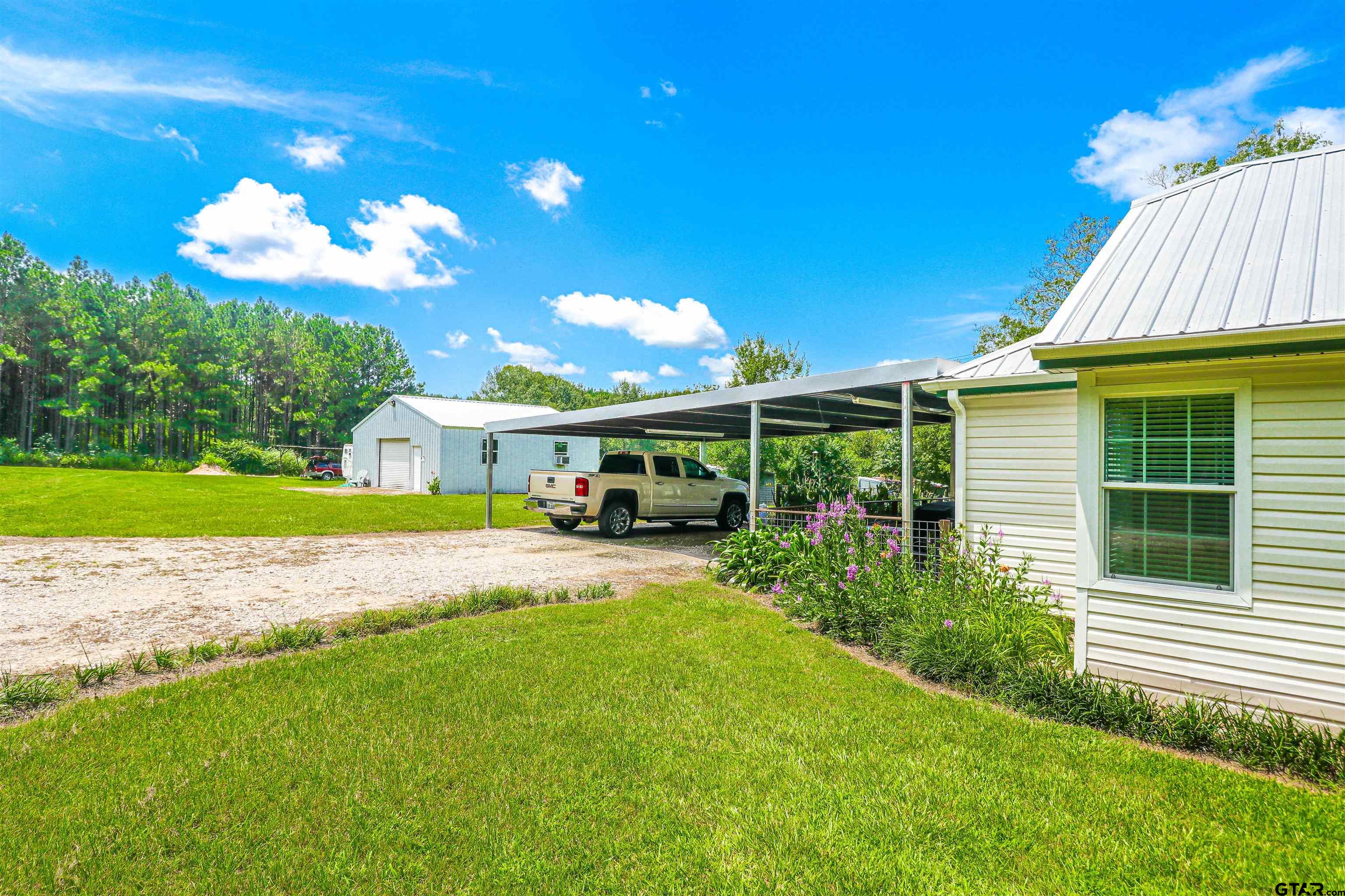 830 County Road 2201 Rusk, TX 75785 - Photo 6 of 40 a view of house with garden space and swimming pool