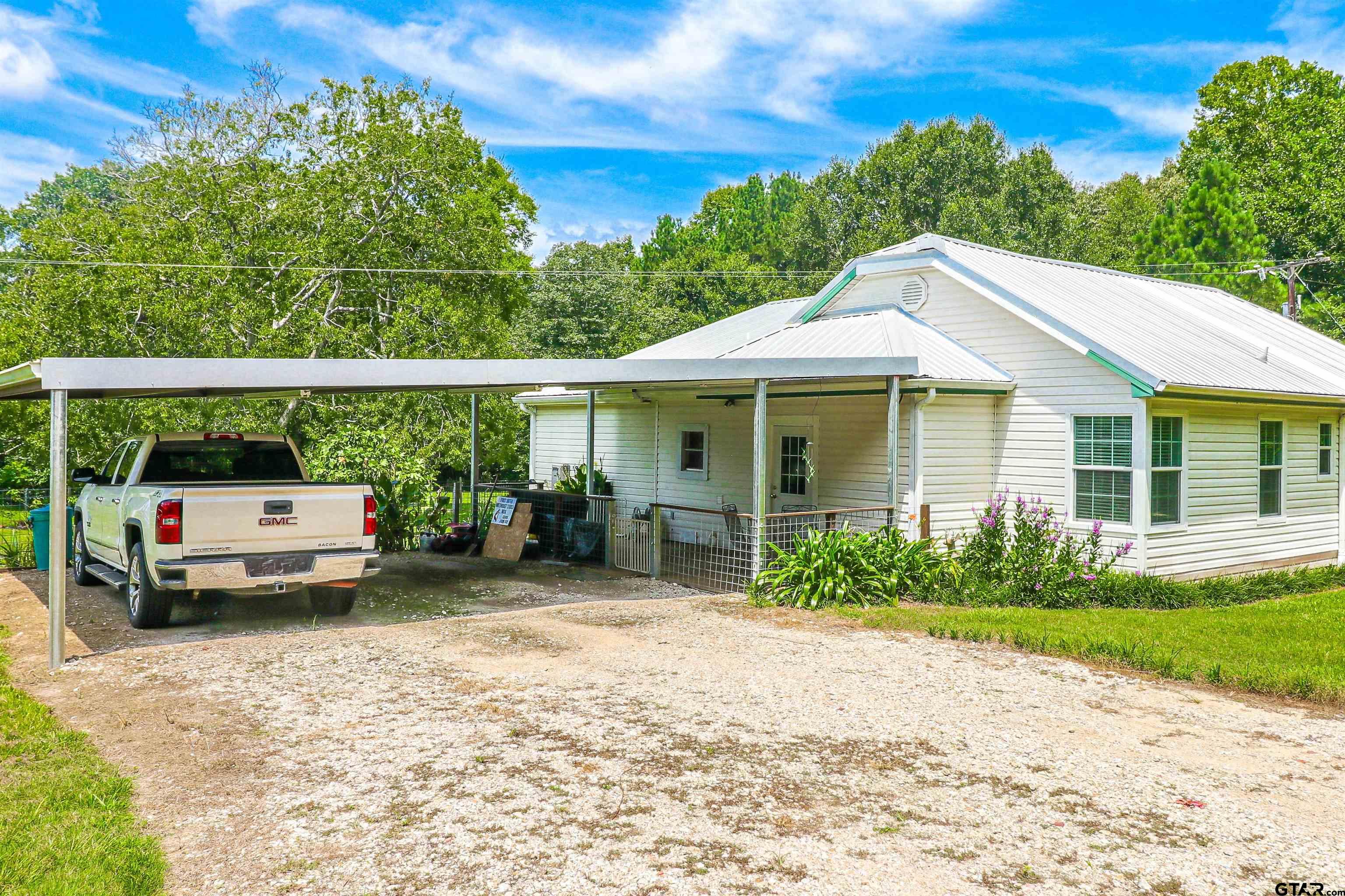 830 County Road 2201 Rusk, TX 75785 - Photo 7 of 40 a view of a house with a garden and pathway