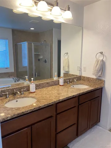 a bathroom with a granite countertop sink a large mirror and a