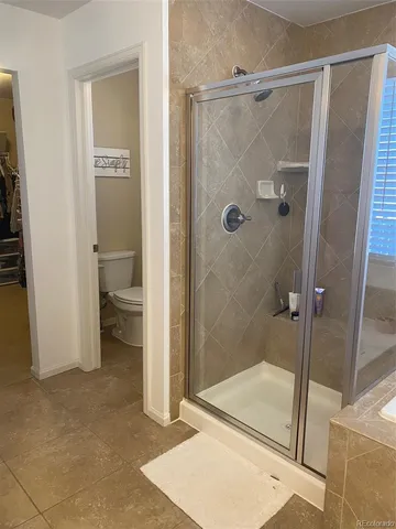 a bathroom that has a glass shower door