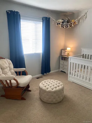 a bedroom with furniture and chandelier