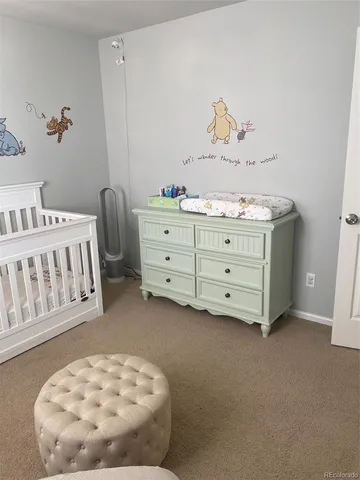 a bed room with a bed and a chair