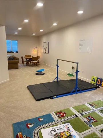 a living room with furniture a rug and a projector