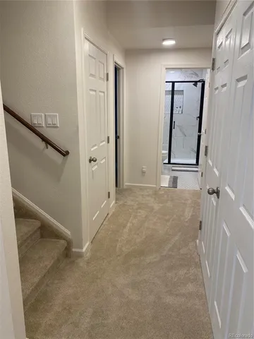 a bedroom with a bed and a lamp on dresser