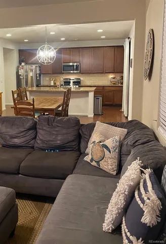 a living room with furniture and kitchen view