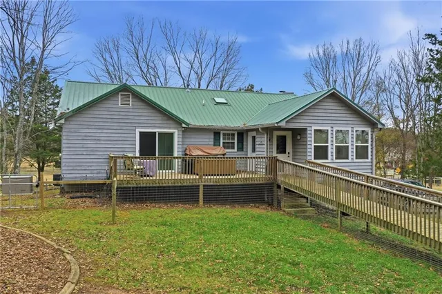 a view of roof deck with wooden floor and fence