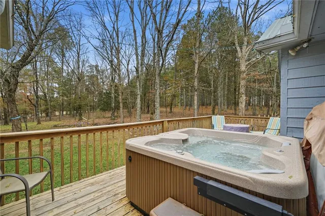 a view of a balcony with wooden floor and outdoor seating