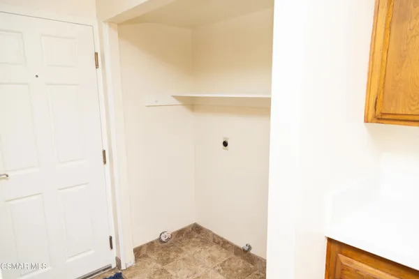a view of a kitchen with a sink and cabinets