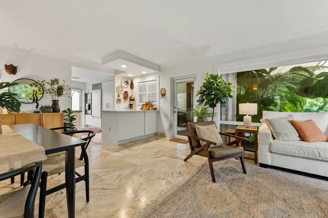 a dining room with furniture and a large window