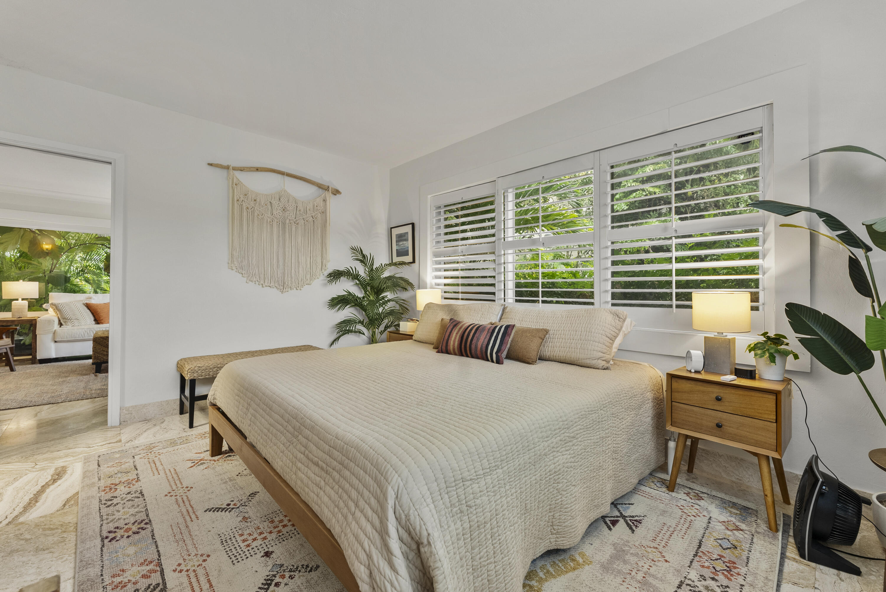 1202 Hillsboro Mile, Unit 2A Hillsboro Beach, FL 33062 - Photo 16 of 54 a bedroom with a bed a bookshelf and a large window