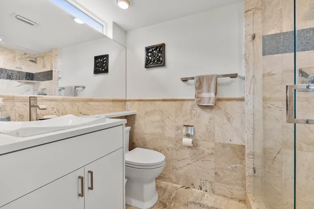 a bathroom with a toilet and a shower