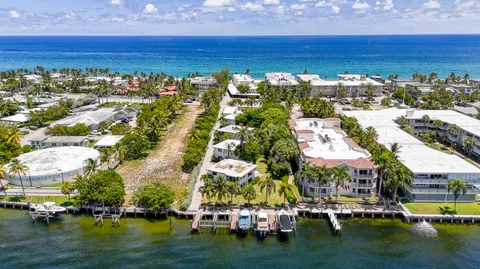 a view of a house with brick walls and a yard with plants
