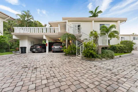 an aerial view of a residential houses with outdoor space and street view