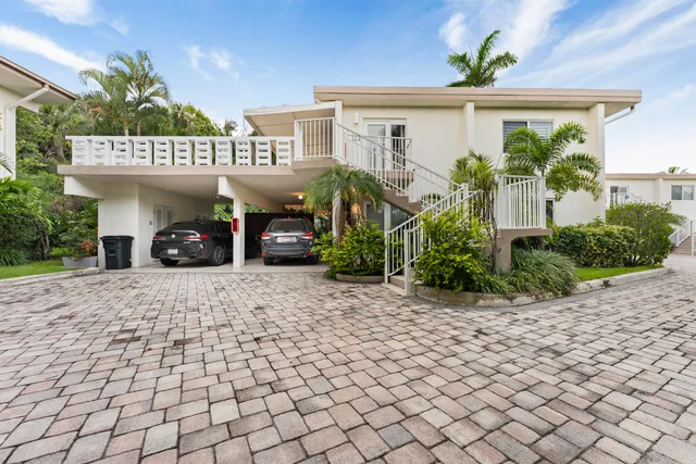 an aerial view of a residential houses with outdoor space and street view