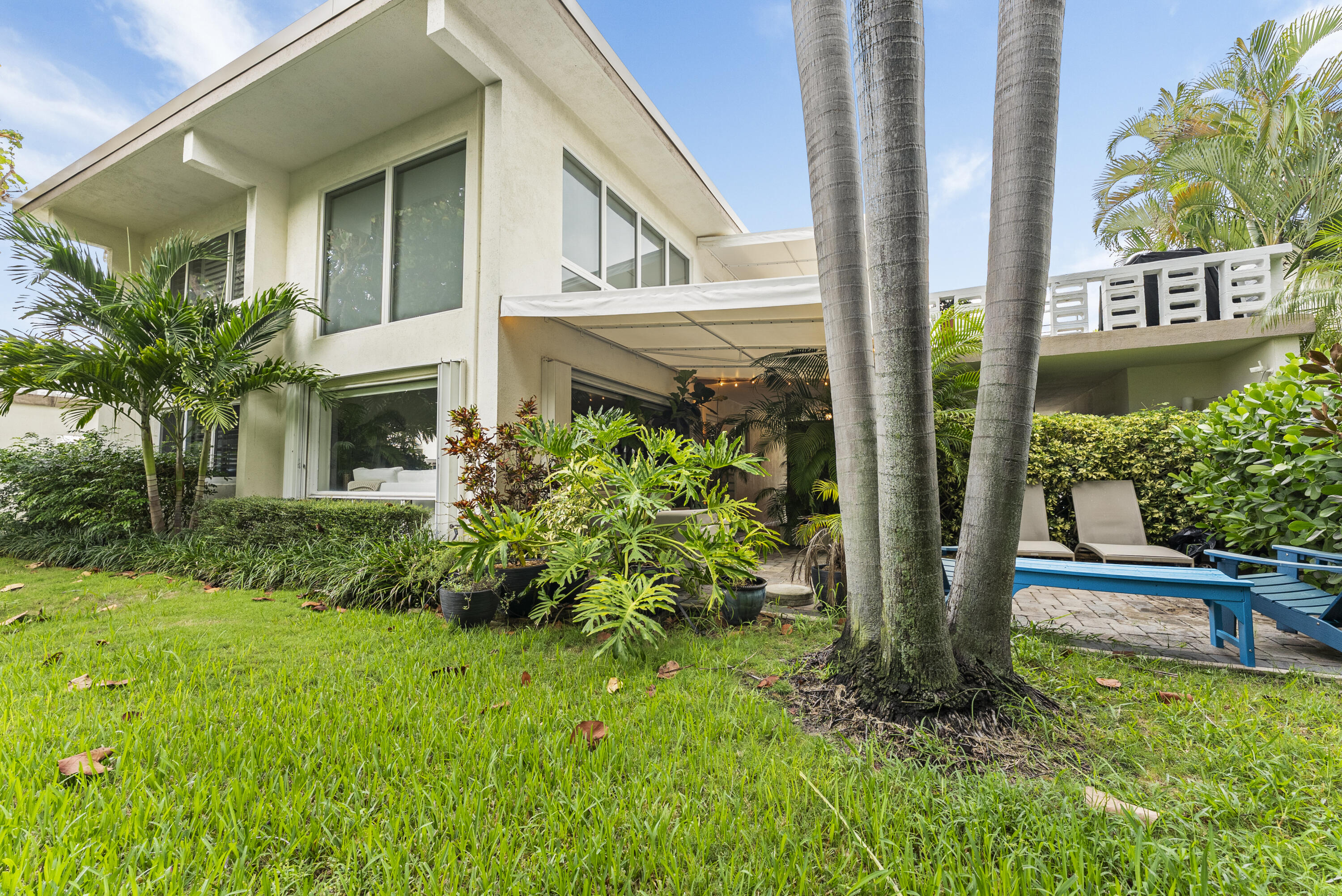 1202 Hillsboro Mile, Unit 2A Hillsboro Beach, FL 33062 - Photo 37 of 54 a view of a house with brick walls and a yard with plants