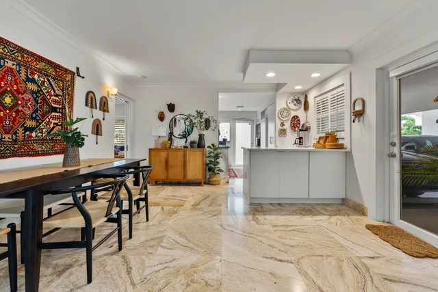 a living room with furniture potted plant and a large window