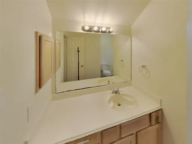 a bathroom with a sink a vanity a mirror and shower