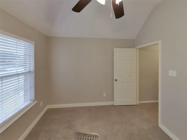 a view of an empty room with windows