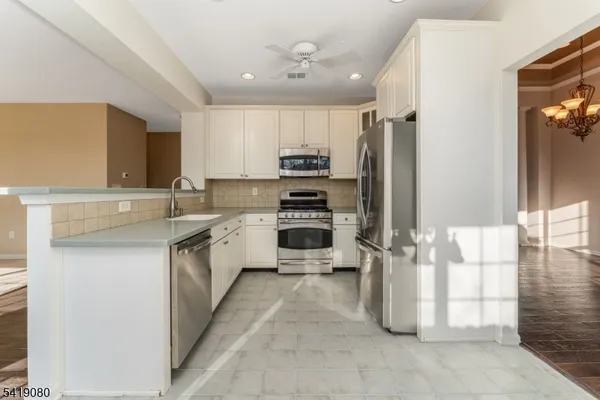 a kitchen with a sink cabinets and stainless steel appliances