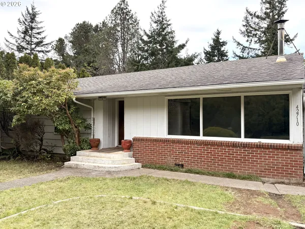 a view of a house with a garden and yard