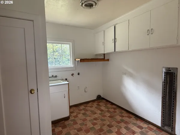 a view of a storage and utility room with closet