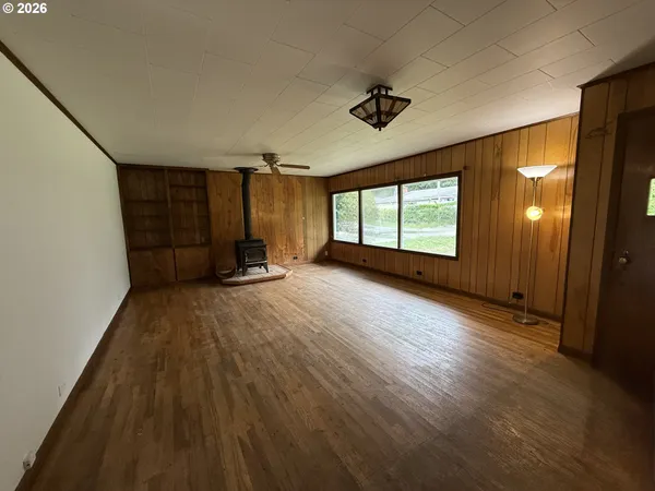 a view of a room with wooden floor and windows