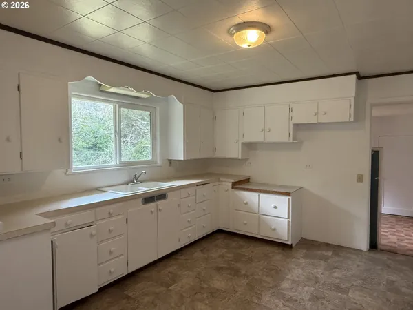 a kitchen with sink and cabinets