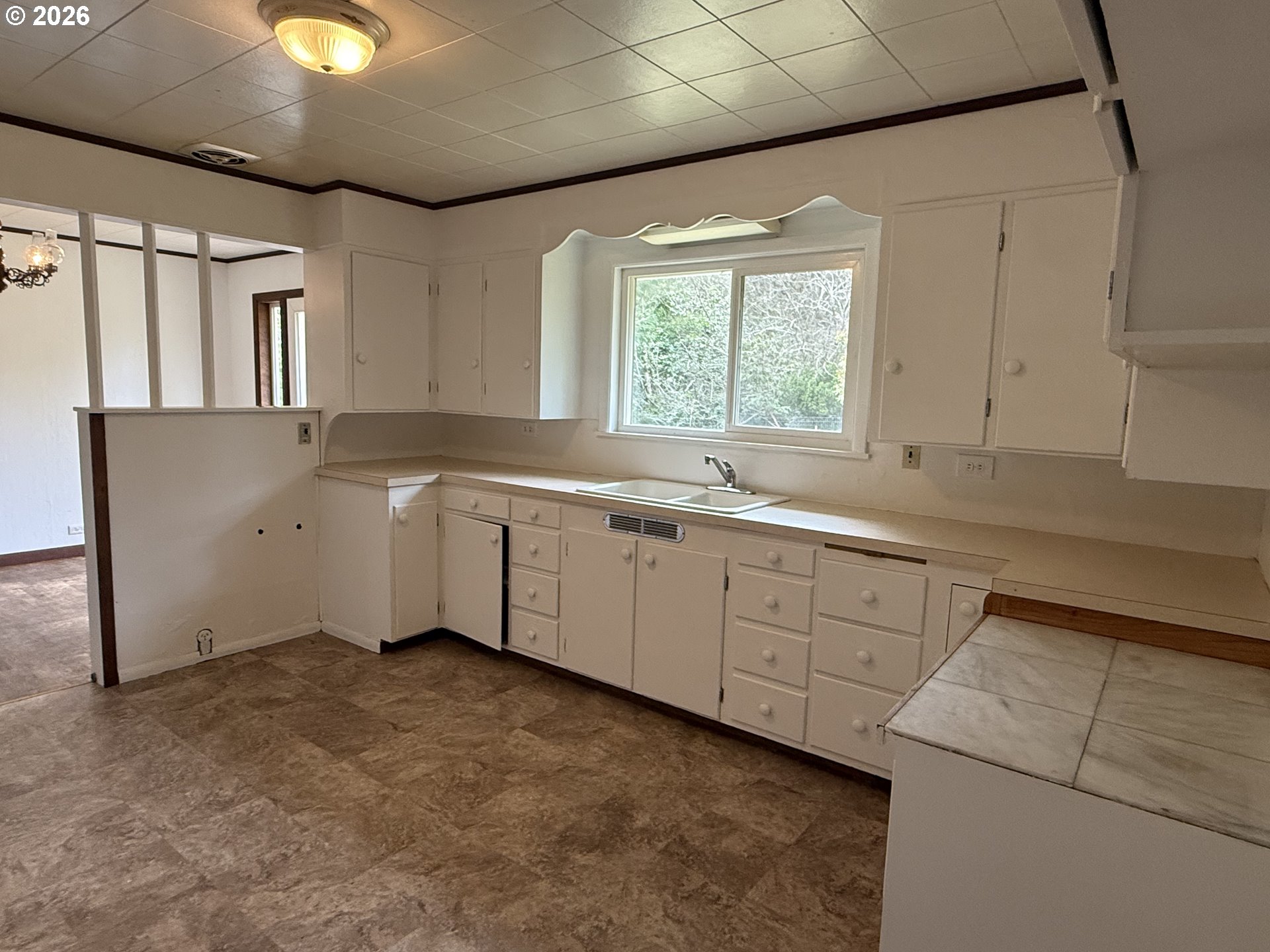 42710 Silver Springs Road Port Orford, OR 97465 - Photo 6 of 21 a kitchen with sink cabinets and window