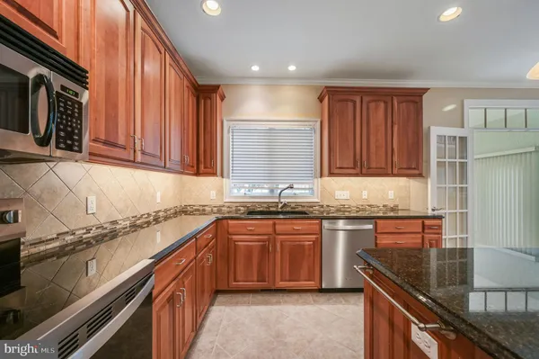 a kitchen with stainless steel appliances granite countertop counter space a sink and cabinets