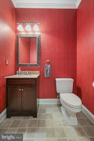 a bathroom with a toilet a sink and mirror