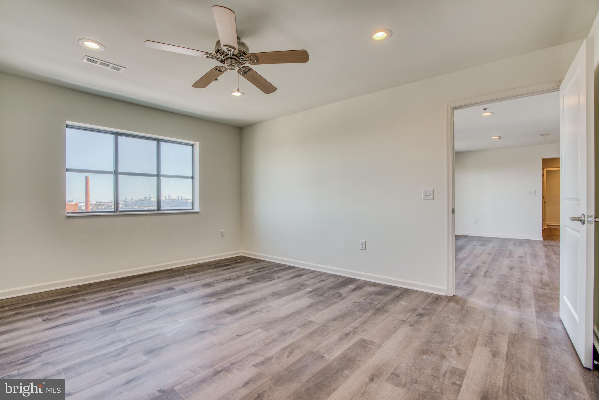 2702 Lighthouse Point East, Unit 626 Baltimore, MD 21224 - Photo 23 of 60 Primary bedroom with lovely view & hardwood floor