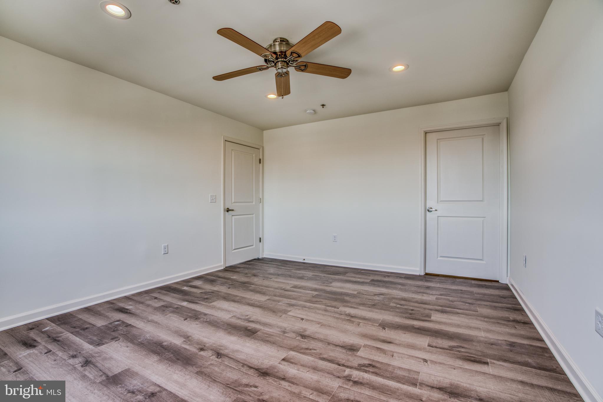 2702 Lighthouse Point East, Unit 626 Baltimore, MD 21224 - Photo 24 of 60 Primary bedroom with hardwood floor