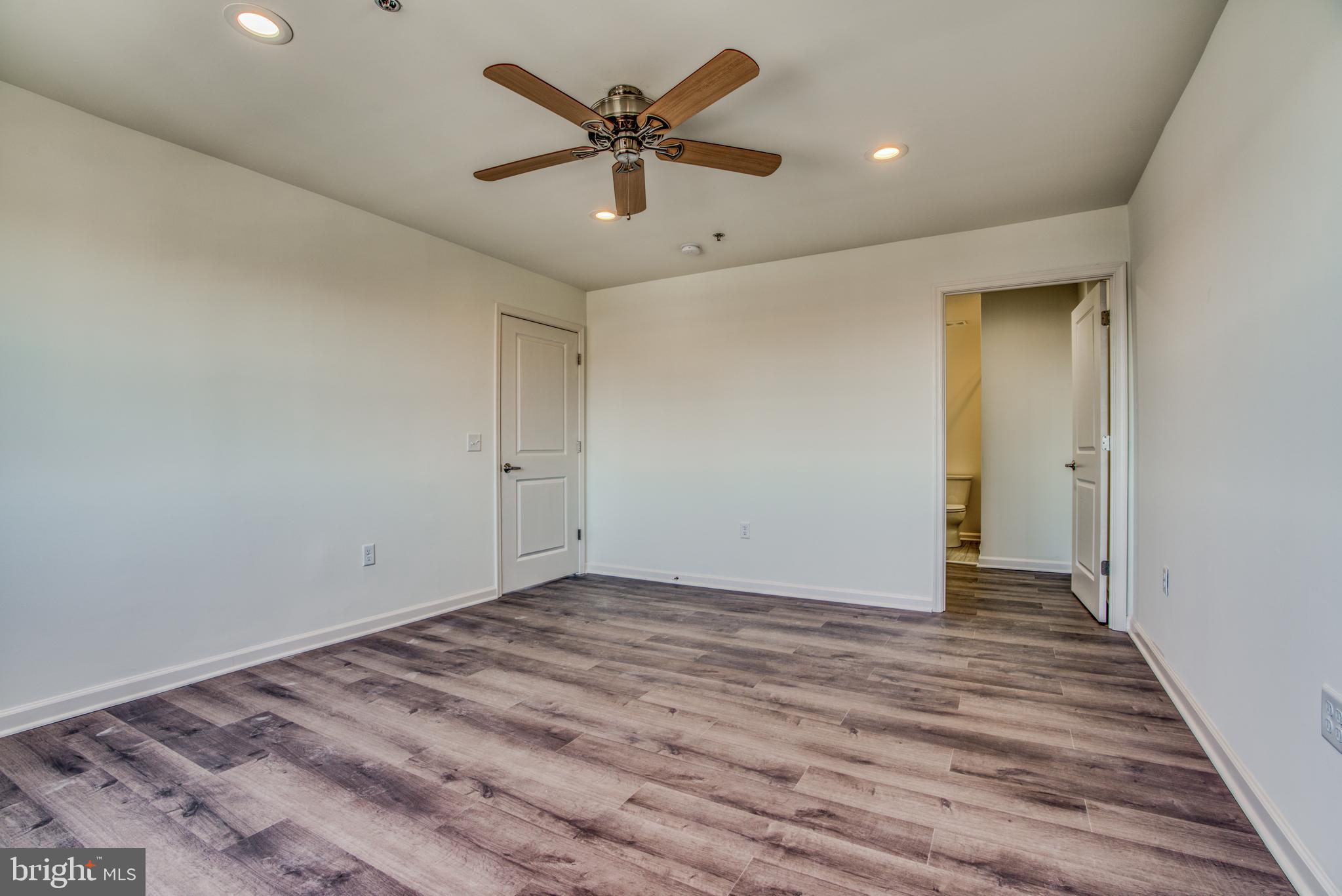 2702 Lighthouse Point East, Unit 626 Baltimore, MD 21224 - Photo 25 of 60 Primary bedroom with hardwood floor