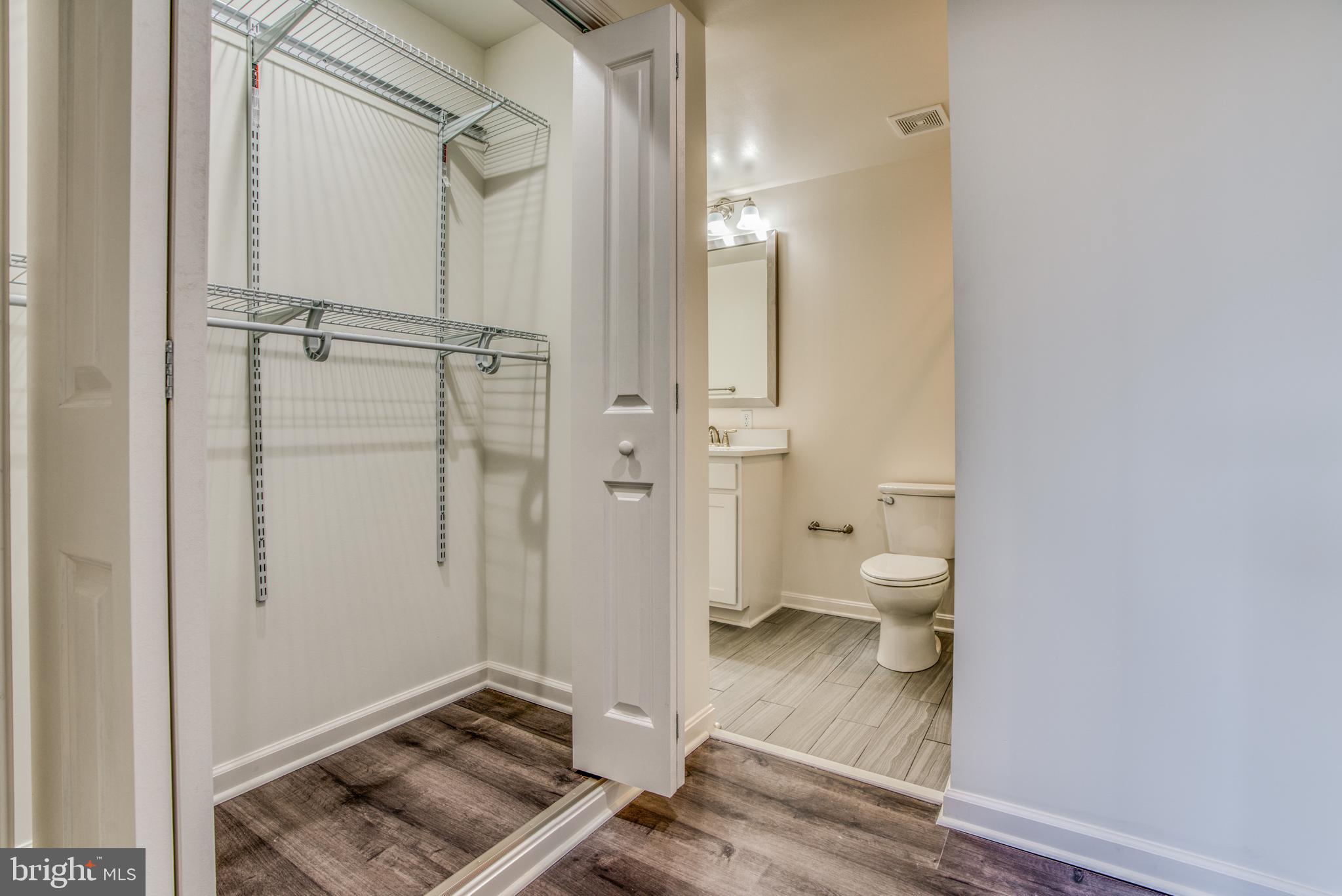 2702 Lighthouse Point East, Unit 626 Baltimore, MD 21224 - Photo 27 of 60 Closet and primary bathroom