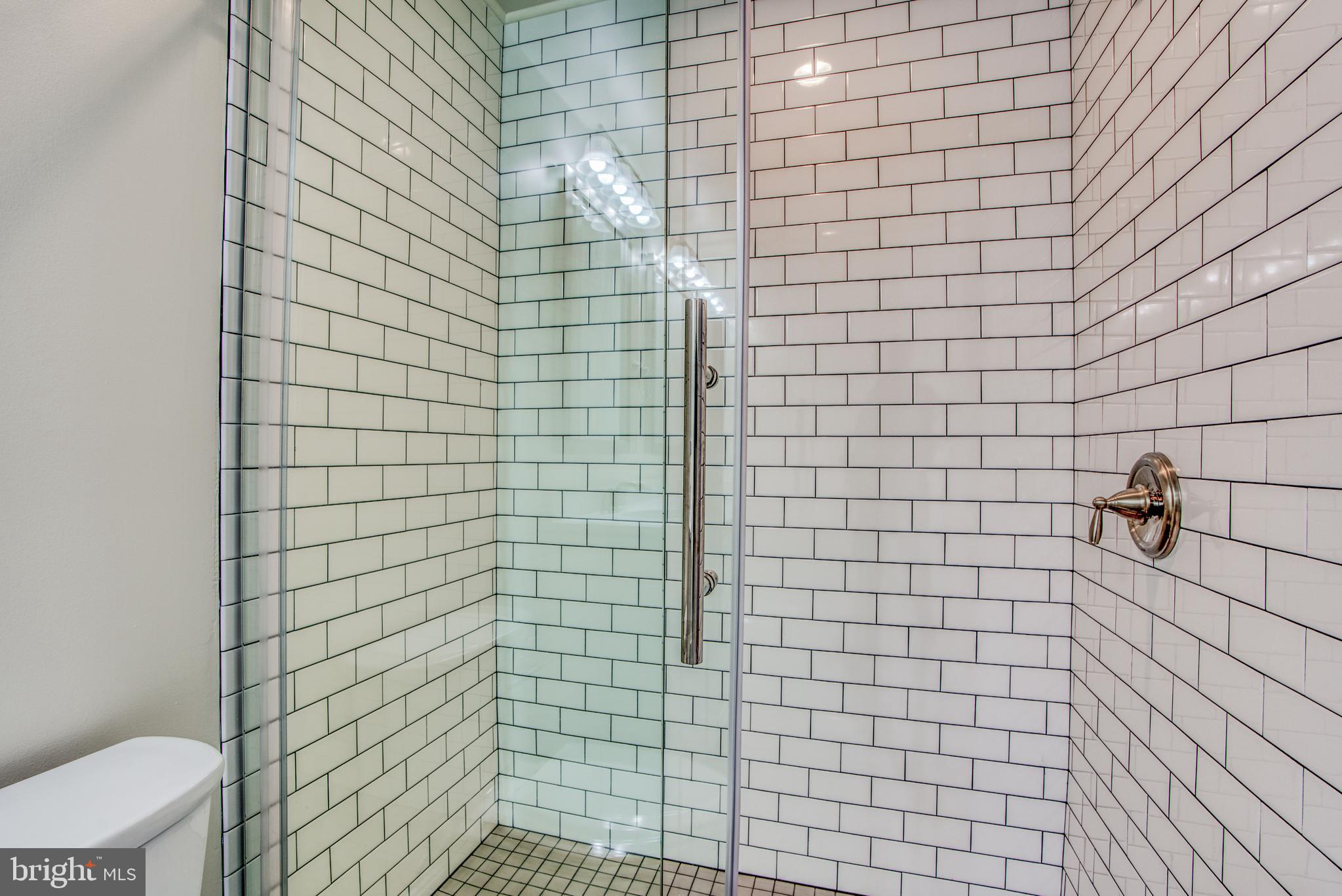 2702 Lighthouse Point East, Unit 626 Baltimore, MD 21224 - Photo 30 of 60 Updated stall shower in primary bathroom