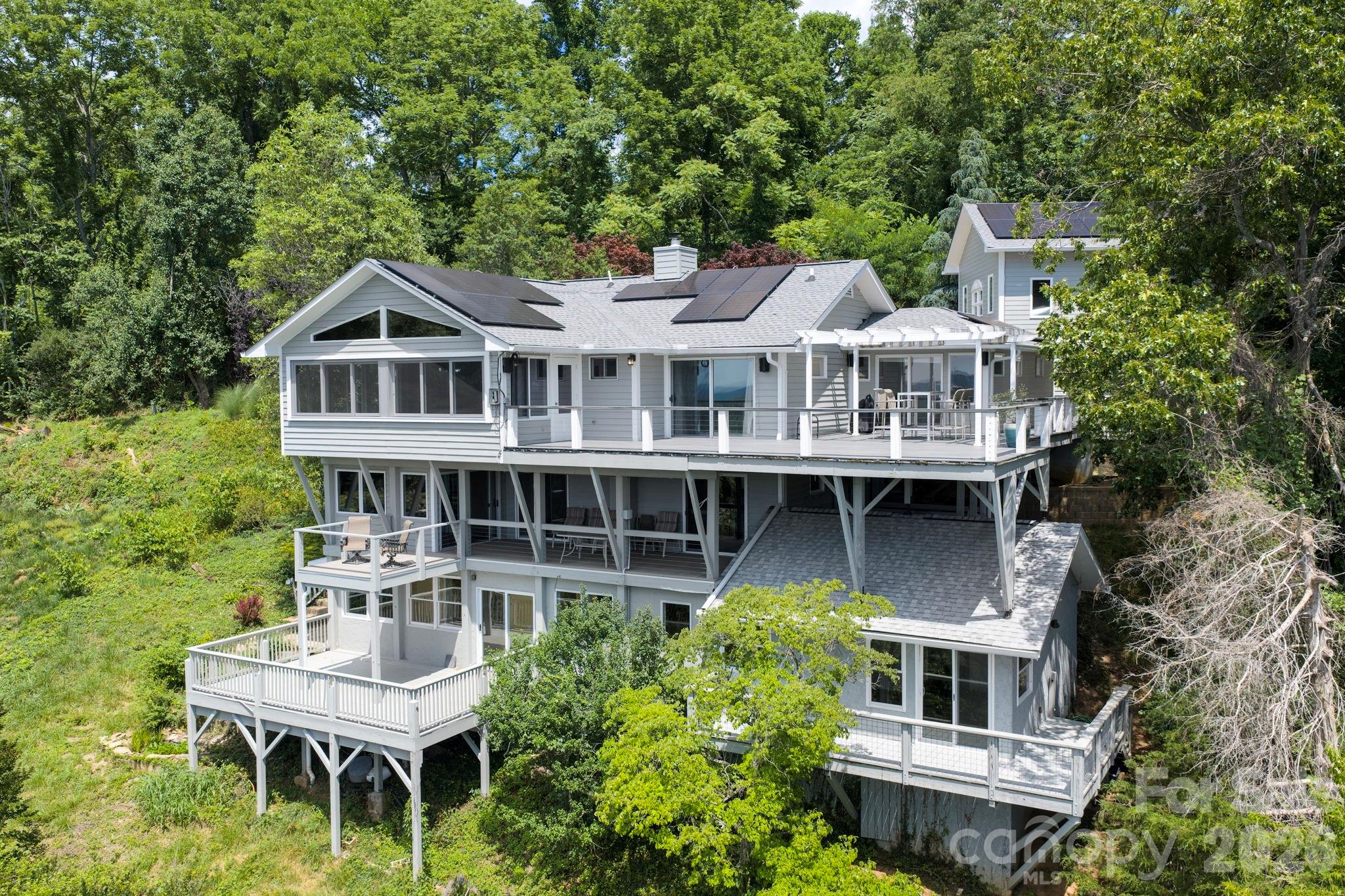 38 Lookout Road Asheville, NC 28804 - Photo 6 of 34 a balcony with a table and chairs and a barbeque