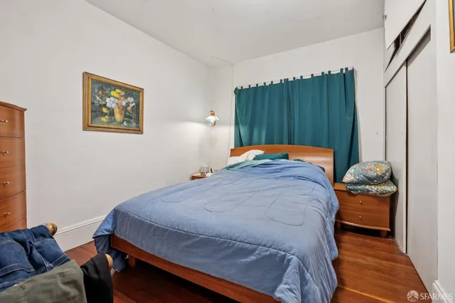 a bed sitting in a bedroom next to a window