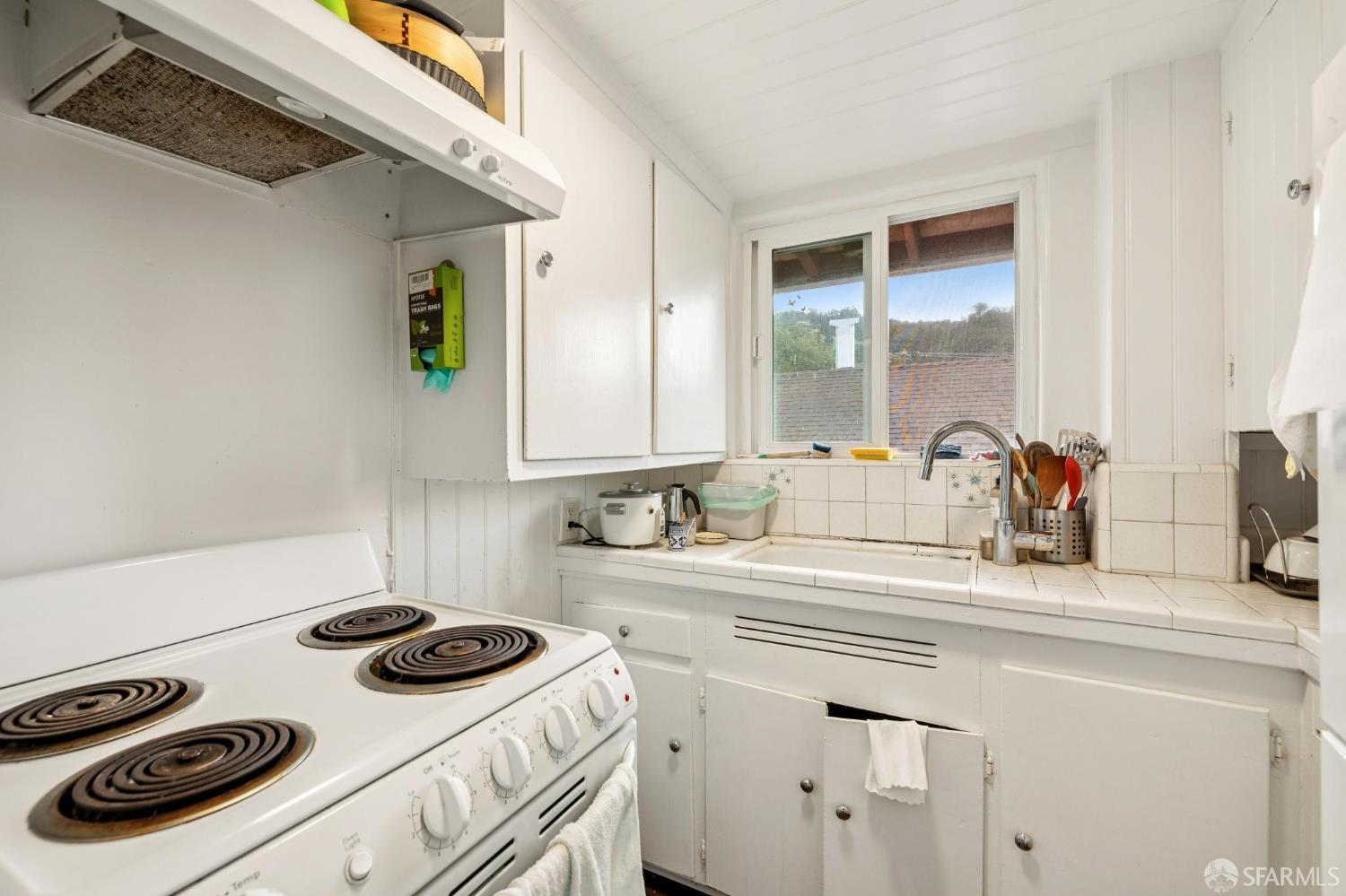 2732 Parker Street Berkeley, CA 94704 - Photo 23 of 25 a kitchen with a sink stove and cabinets